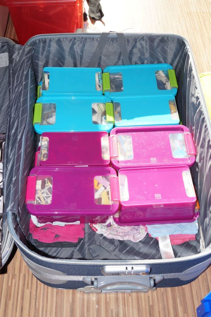 Boxes of Lego and cables serve as a base for the suitcase.