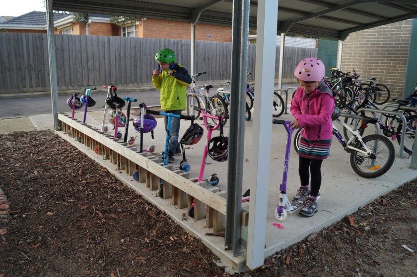 In the bike shet, there is a place just for scooters. Kai feels right at home.