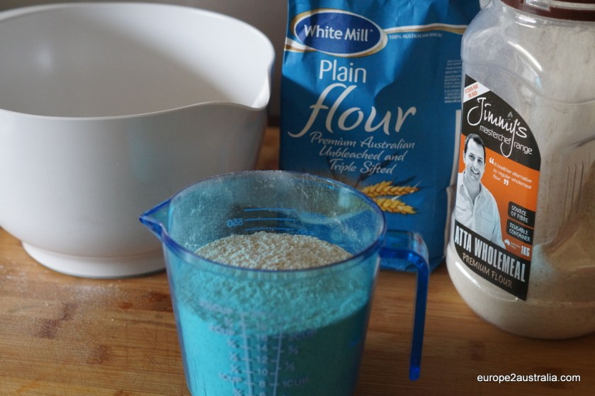 Add four cups of flour to a big mixing bowl.
