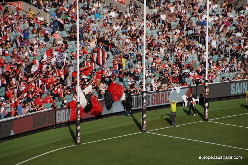 After he (or she) has done that, he waves two white flags to indicate to the ref at the other end of the oval that 6 points were scored.